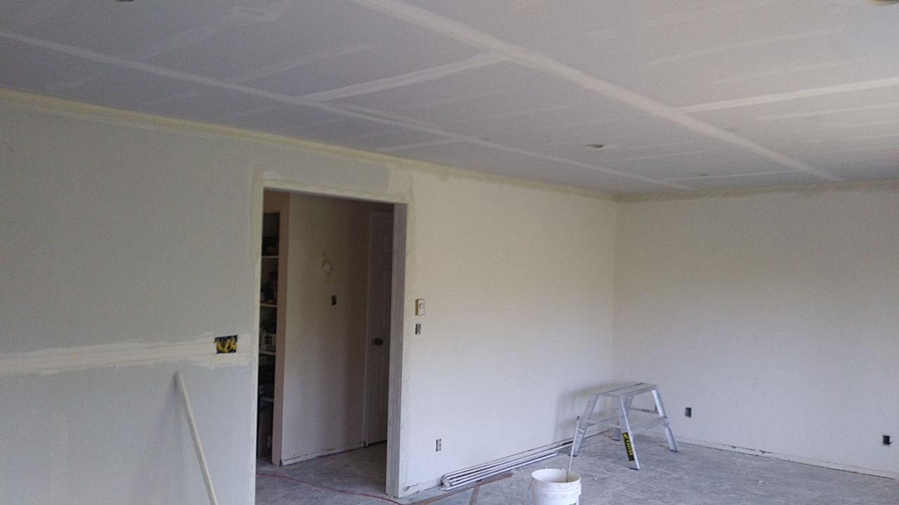 New ceiling and walls first coating on the drywall installation New ceiling and walls first coating on the drywall installation